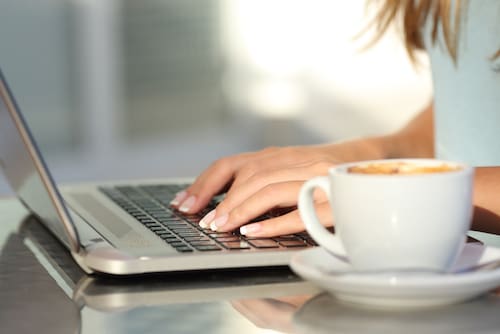 Woman typing at laptop