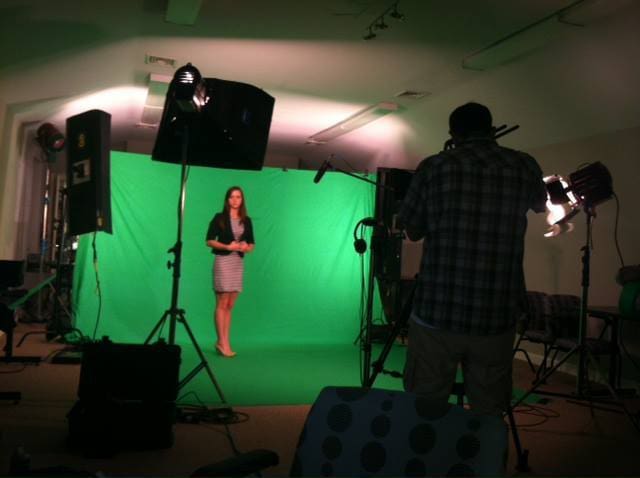 Woman standing in front of green screen