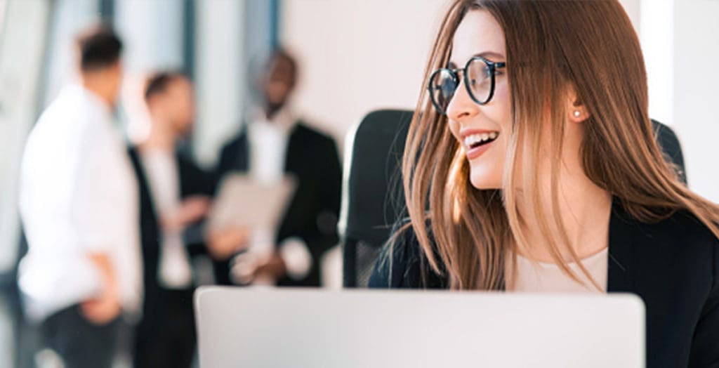 Woman smiling while sitting at computer