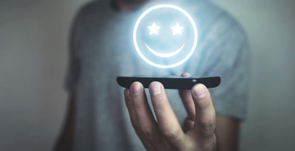 holographic happy face above phone screen