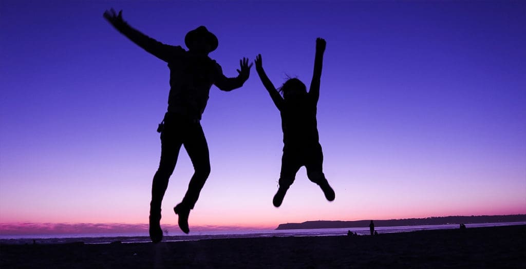 Two people jumping