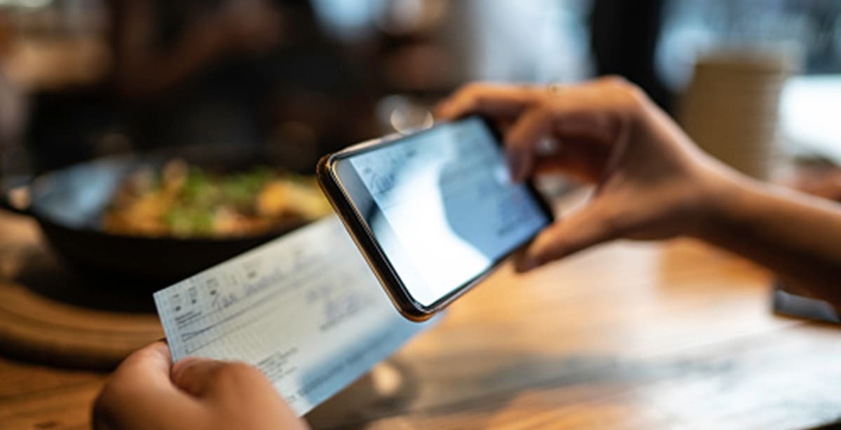 Person taking a photo of a check for deposit