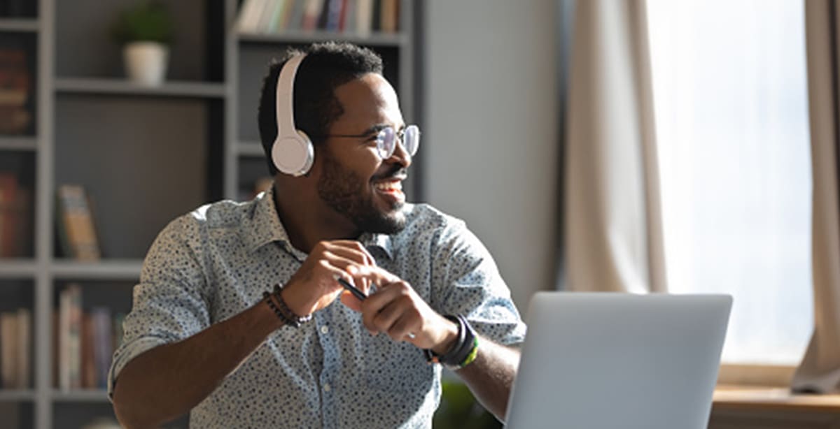 Man at computer with headphones on