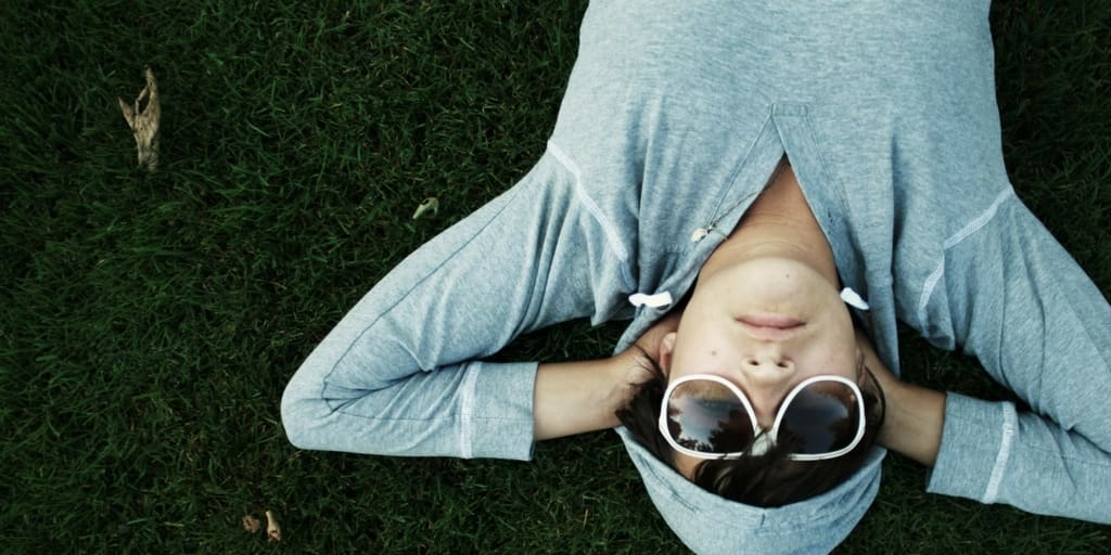 Someone lying on the grass staring at the sky