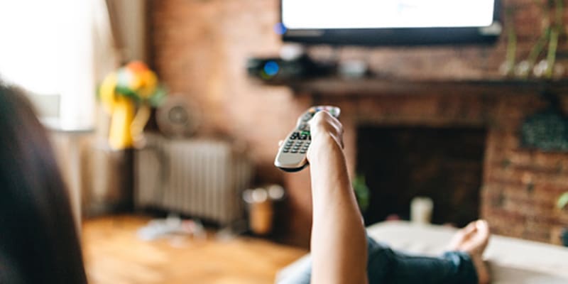 Woman changing the tv channel