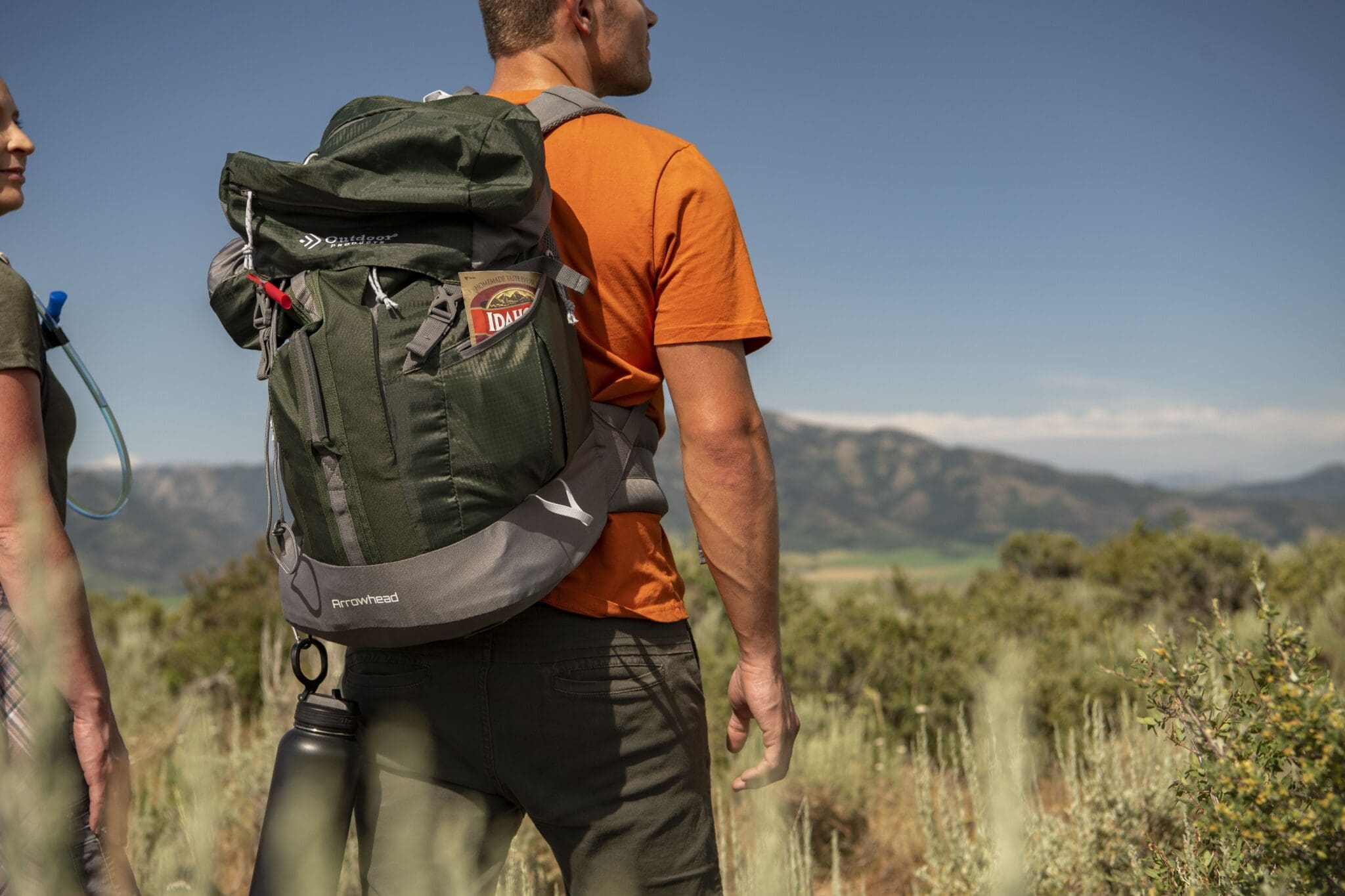 Man hiking, wearing book bag