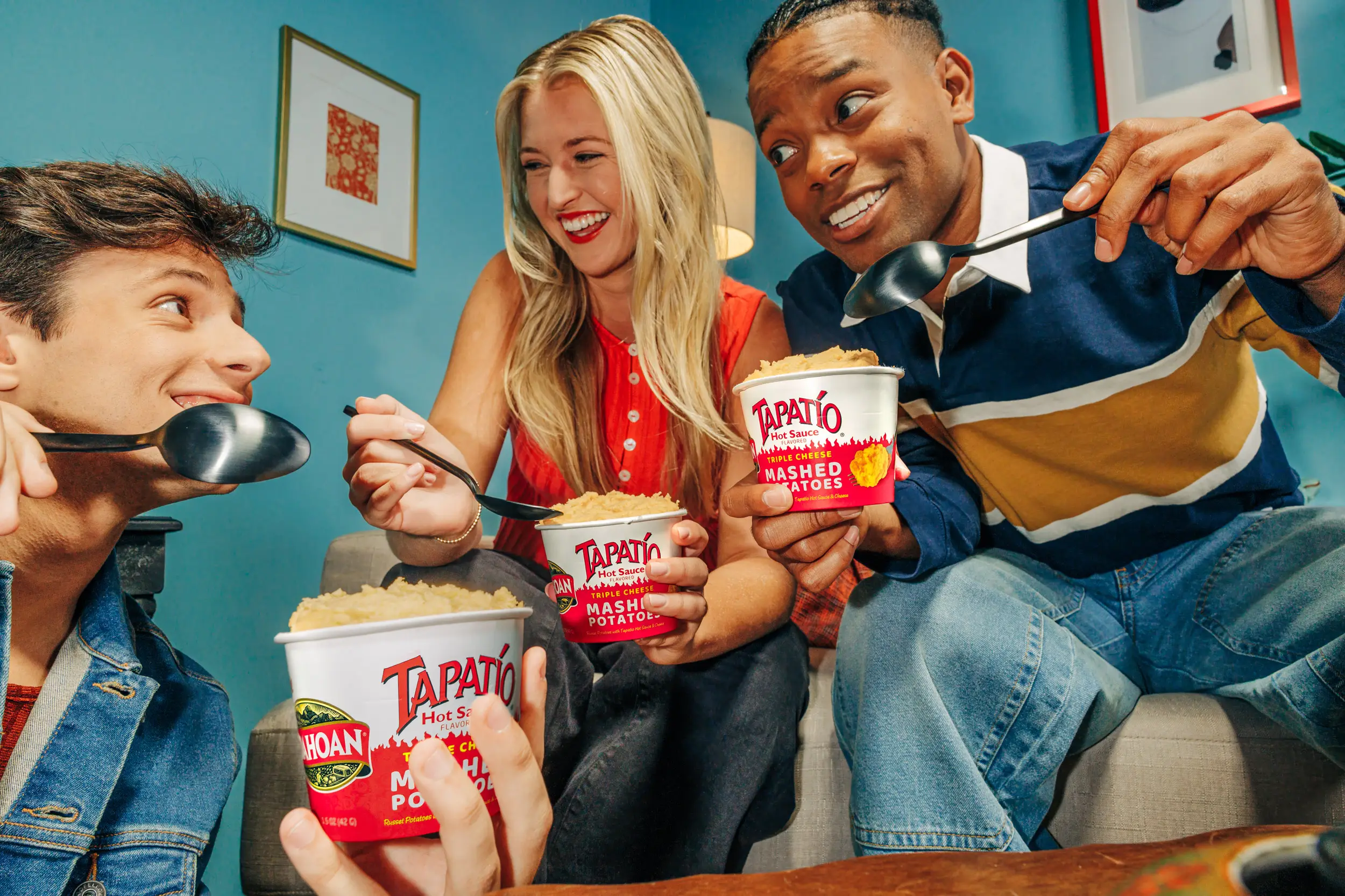 2 guys and girl holding mashed potato cups