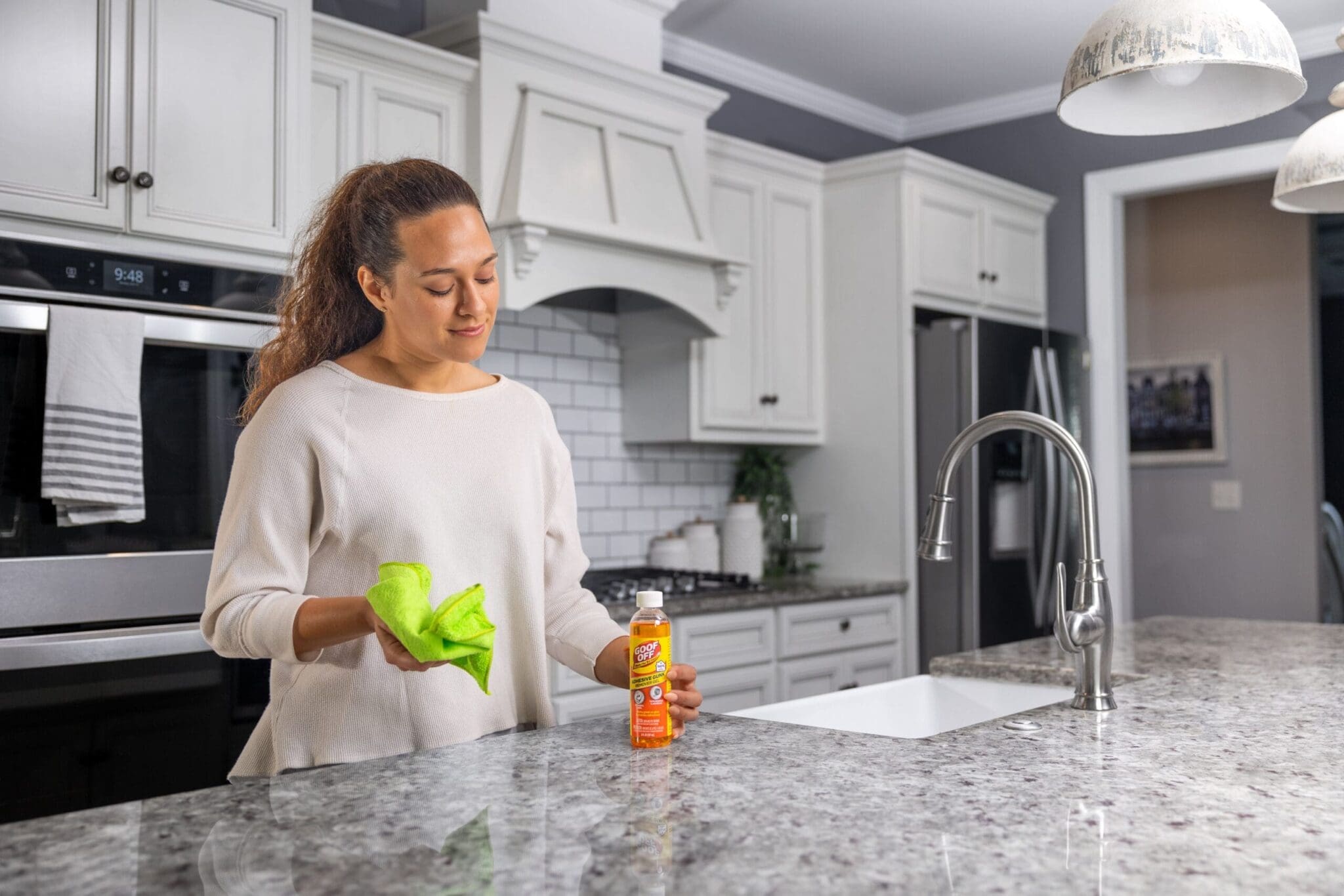 Woman about to use Goof Off on her kitchen counter