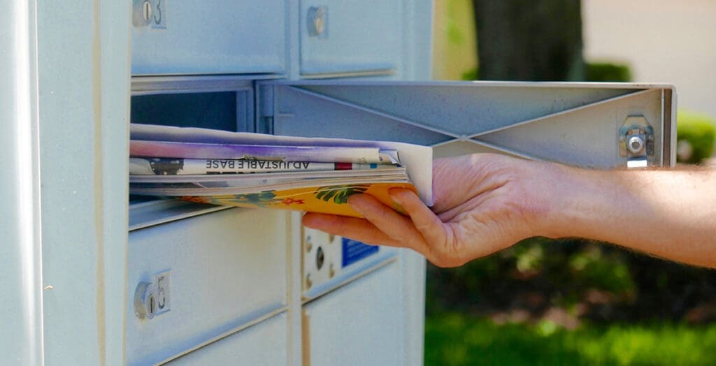 hand pulling mail out of mail box