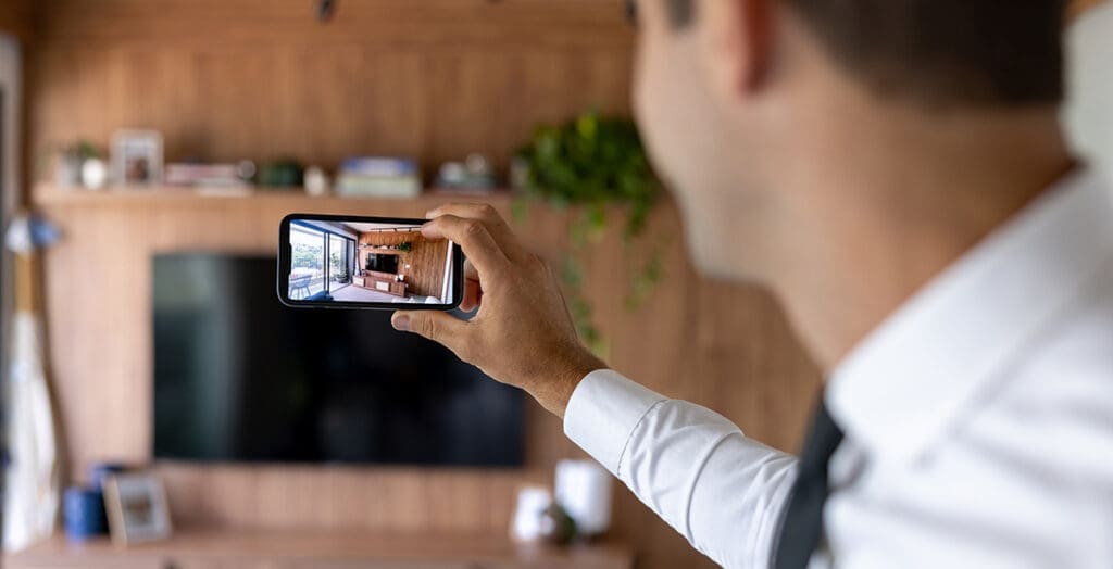 Man taking a photo of living area