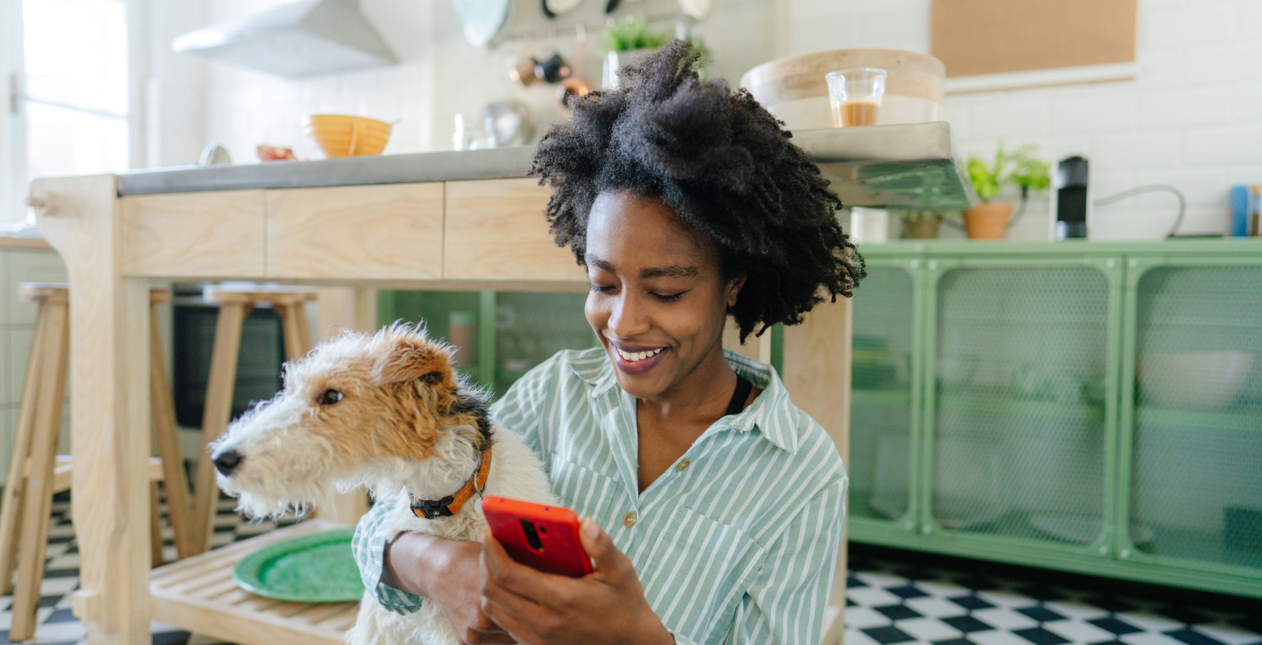Girl holding phone and dog